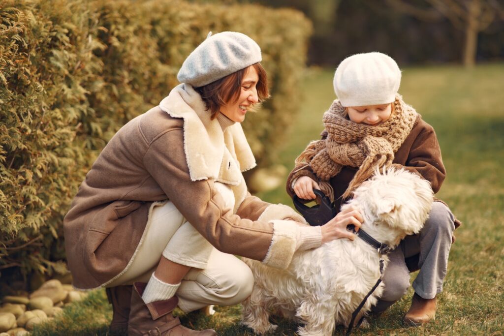 Mother with daughter walks with a dog
