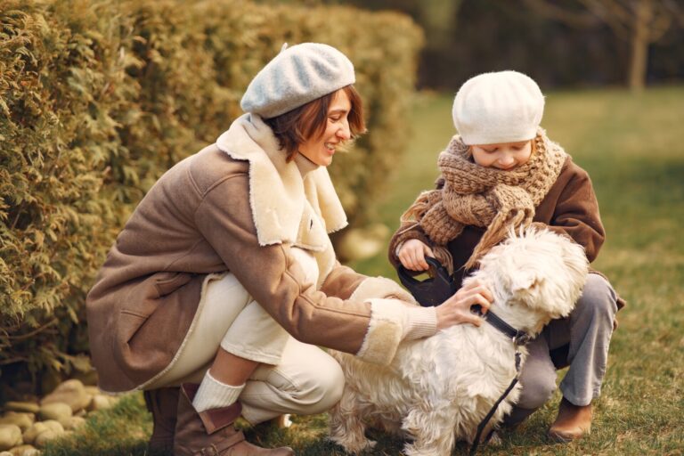Mother with daughter walks with a dog