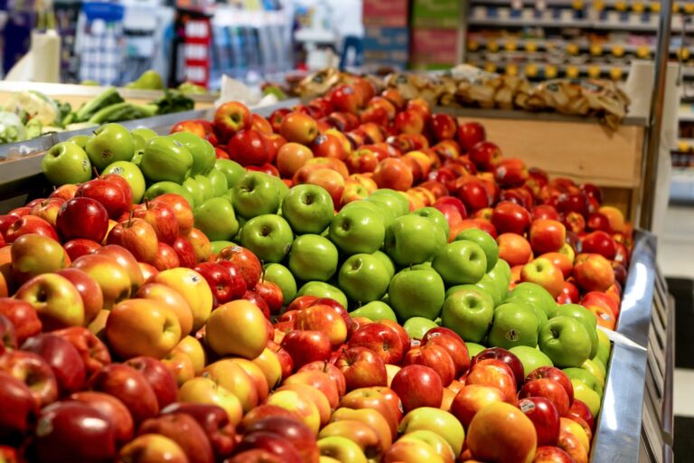 Various green and red apples at the supermarket display. Fruits shopping store retail