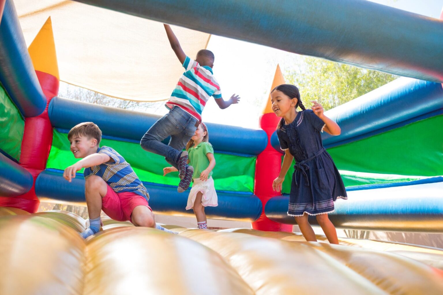 Friends jumping on bouncy castle at country shows