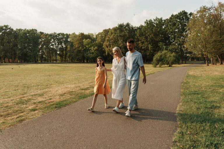 Family walking together in a park - car-free holidays