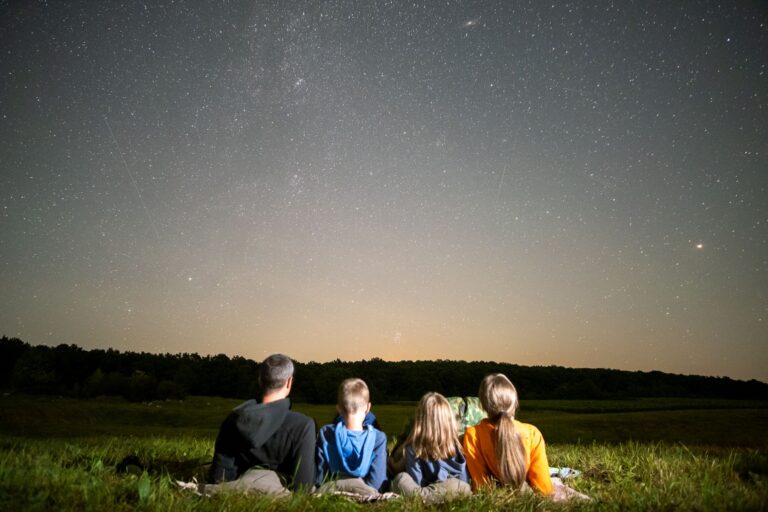family sitting under the stars